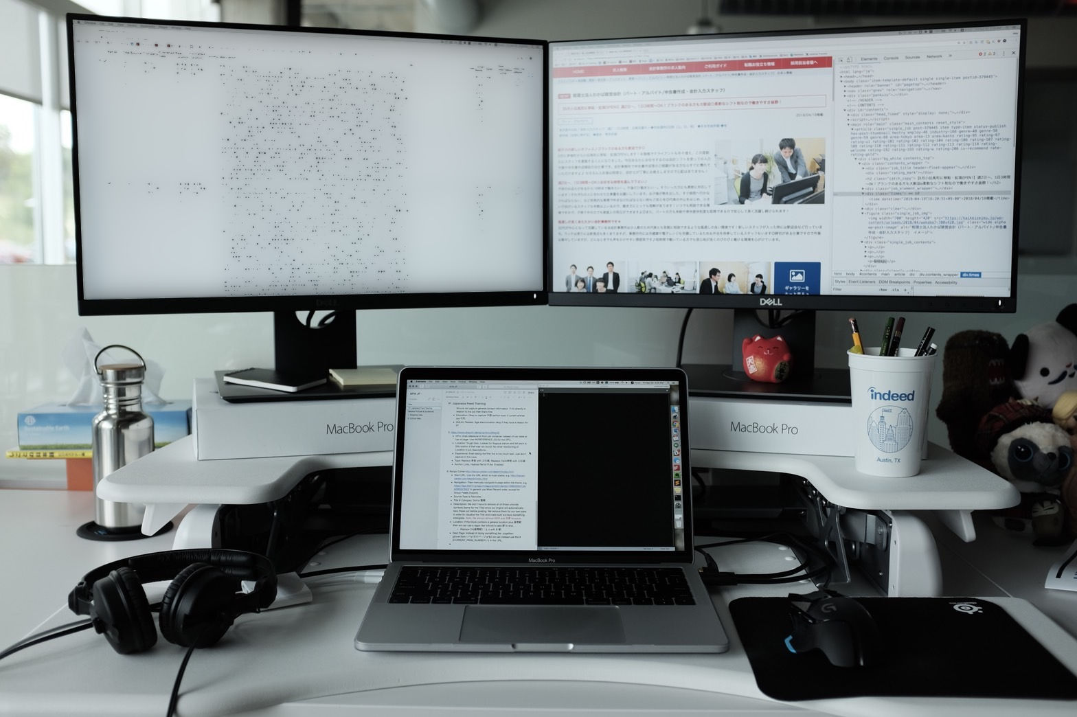 View of my desk setup at Indeed circa 2019. Two monitors connected to a laptop with Chrome DevTools open.